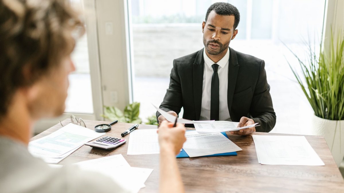 Trust Fund Recovery Penalty Defense in Orlando, FL Professional reviewing documents with a client