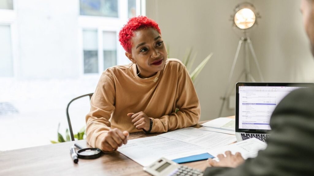 Woman talking through paperwork during a consultation