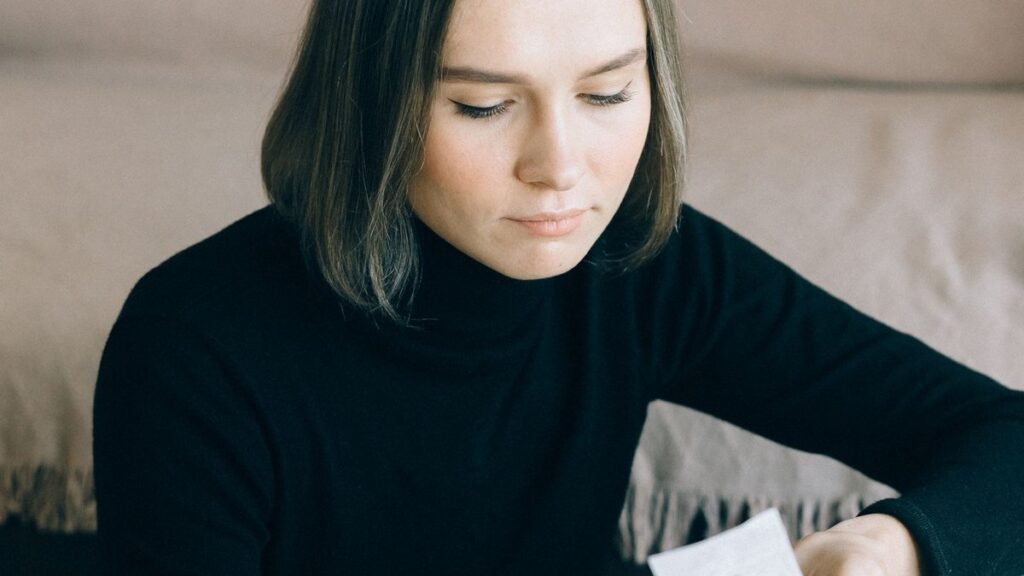 Woman looking over a bill at home